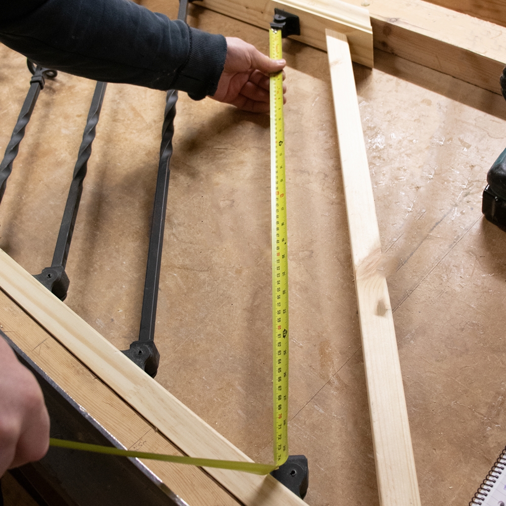 Measuring the distance between bracket to bracket for metal spindle installation. 