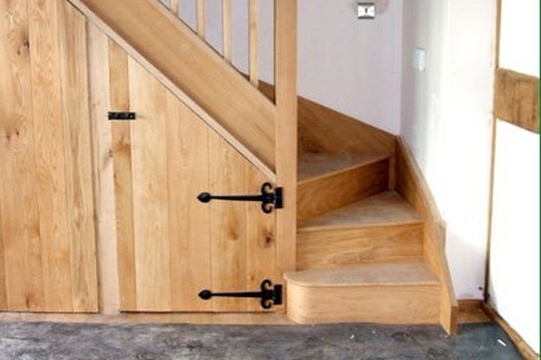 Rustic looking staircase in natural timber with under stair storage
